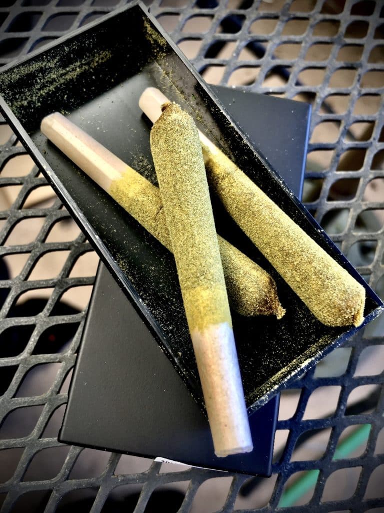 Three cannabis prerolls infused with extract, concentrate, and kief for sale at a Michigan weed dispensary.