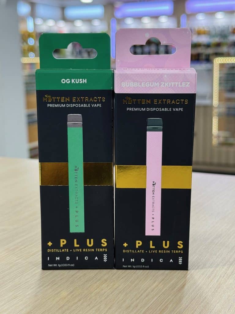 Two premium disposable cannabis vapes from Mitten Extracts featuring OG Kush and Bubblegum Zkittlez strains.